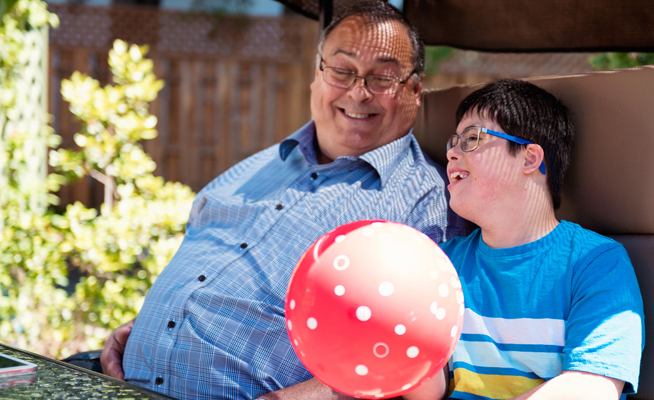 grandfather enjoying a sunny day with his special needs grandson.