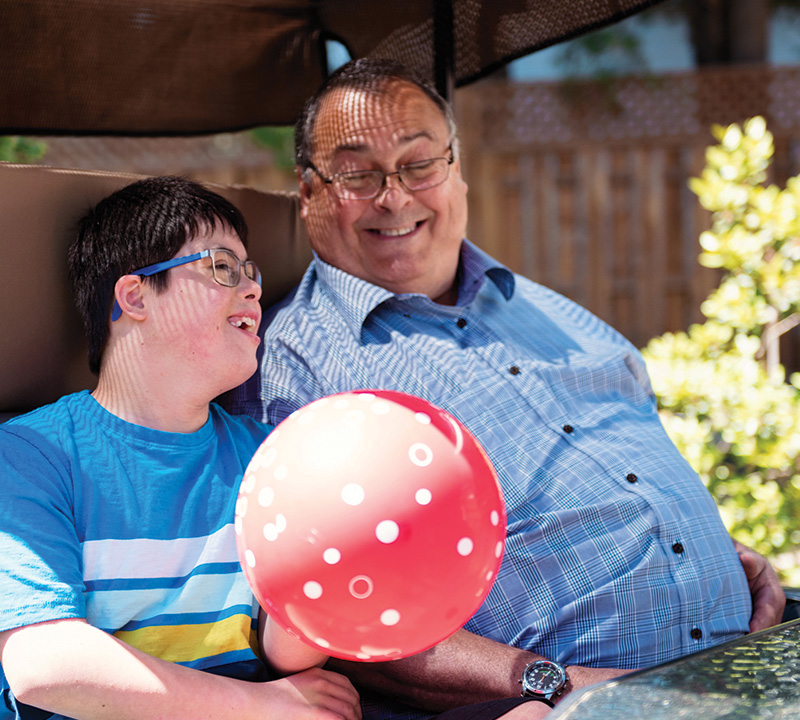 grandfather enjoying a sunny day with his special needs grandson.